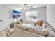 Cozy living room featuring a plush sectional sofa, ceiling fan, and a mounted flatscreen television at 5626 Wyncreek Sw Cir, South Fulton, GA 30331