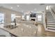 Open-concept living room featuring a fireplace, granite kitchen island, and natural lighting at 5626 Wyncreek Sw Cir, South Fulton, GA 30331