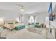 Spacious main bedroom with a large bed, sitting area, soft carpet, and modern light fixture at 5626 Wyncreek Sw Cir, South Fulton, GA 30331