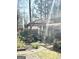 Lush backyard featuring a tranquil pond, bridge and vibrant landscaping at 8806 Clear Creek Ct, Douglasville, GA 30135