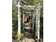 Lush garden path leading through a white arbor with hanging lamps at 8806 Clear Creek Ct, Douglasville, GA 30135