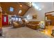 Open living room with high ceiling, red door and leather furniture at 8806 Clear Creek Ct, Douglasville, GA 30135