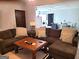 Open living room with sectional sofa and view into kitchen at 8806 Clear Creek Ct, Douglasville, GA 30135