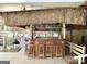 Outdoor tiki bar with stools and tropical decor overlooking a pond at 8806 Clear Creek Ct, Douglasville, GA 30135