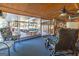 Sunroom with wooden ceiling, comfortable seating and view of deck at 8806 Clear Creek Ct, Douglasville, GA 30135
