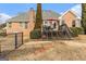 Brick home with deck, patio furniture, and grilling area at 600 English Ct, Mcdonough, GA 30252