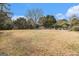 Large backyard with grassy area, trees, and pool at 600 English Ct, Mcdonough, GA 30252