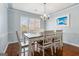 Bright dining room featuring hardwood floors, modern chandelier, and large window at 600 English Ct, Mcdonough, GA 30252