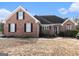 Brick house with a large front yard and mature trees at 600 English Ct, Mcdonough, GA 30252
