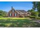 Charming brick home with lush green lawn and mature landscaping at 600 English Ct, Mcdonough, GA 30252