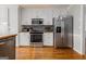 Kitchen with white cabinets and stainless steel appliances at 600 English Ct, Mcdonough, GA 30252