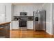 Modern kitchen with stainless steel appliances and sleek white cabinetry at 600 English Ct, Mcdonough, GA 30252