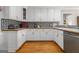 Well-appointed kitchen featuring white cabinets, wood countertops, and modern backsplash at 600 English Ct, Mcdonough, GA 30252