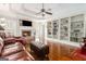 Comfortable living room with cozy fireplace and custom built-in shelving at 600 English Ct, Mcdonough, GA 30252