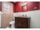 Bathroom with granite vanity, red walls, and a shower stall at 5546 Stoneybrook Se Ct, Mableton, GA 30126
