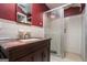 Bathroom includes a shower, granite vanity, and red walls at 5546 Stoneybrook Se Ct, Mableton, GA 30126