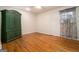 Bedroom with hardwood floors, green armoire, and window with curtains at 5546 Stoneybrook Se Ct, Mableton, GA 30126