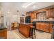 Kitchen features an island, wood cabinets, and a view into the dining area at 5546 Stoneybrook Se Ct, Mableton, GA 30126