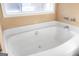 Clean bathroom featuring a white tub beneath a window with natural light at 2618 Windage Sw Dr, Marietta, GA 30008