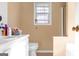 Neutral bathroom featuring a white vanity with sink and toilet with tile floors at 2618 Windage Sw Dr, Marietta, GA 30008