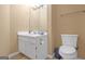 Modest bathroom featuring a white vanity with sink, toilet, mirror and neutral walls at 2618 Windage Sw Dr, Marietta, GA 30008