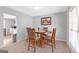 A cozy dining area with carpet, a round wooden table, and natural light from the window at 2618 Windage Sw Dr, Marietta, GA 30008