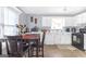 Bright kitchen with white cabinets, modern appliances, table and chairs with natural light at 2618 Windage Sw Dr, Marietta, GA 30008