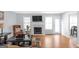 Comfortable living room with hardwood floors, a cozy fireplace, and abundant natural light at 2618 Windage Sw Dr, Marietta, GA 30008