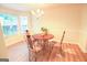 Bright dining area with wood flooring and a wood table set at 4408 Idlewood Park, Lithonia, GA 30038