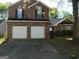 Brick two-story house with a three-car garage and a well-maintained lawn at 4408 Idlewood Park, Lithonia, GA 30038