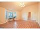Living room with hardwood floors, a chandelier, and access to the stairs at 4408 Idlewood Park, Lithonia, GA 30038