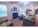 Living room with fireplace, view to kitchen, and patio access at 4408 Idlewood Park, Lithonia, GA 30038