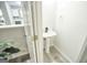 Small, modern bathroom with pedestal sink and gray flooring at 6527 Arbor Gate Sw Dr # Bldg 12, Mableton, GA 30126