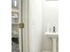 Small, modern bathroom with pedestal sink and gray flooring at 6527 Arbor Gate Sw Dr # Bldg 12, Mableton, GA 30126