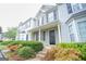 Two-story townhome with gray and white siding, black shutters, and landscaping at 6527 Arbor Gate Sw Dr # Bldg 12, Mableton, GA 30126