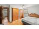 Bedroom with hardwood floors, double door closet and access to bathroom at 200 Old Stagecoach Dr, Stockbridge, GA 30281
