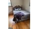 Bedroom with hardwood floors, soft pillows, and a cozy blanket, illuminated by natural light from the window at 200 Old Stagecoach Dr, Stockbridge, GA 30281