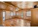 Spacious living room featuring hardwood floors, wood paneling, and multiple windows at 200 Old Stagecoach Dr, Stockbridge, GA 30281