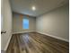 Simple bedroom with large window and wood-look floors at 504 Wylderose Ln, Locust Grove, GA 30248