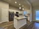 Modern kitchen with white cabinets, granite island, and stainless steel appliances at 504 Wylderose Ln, Locust Grove, GA 30248