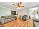 Living room with hardwood floors, a leather couch, and a ceiling fan at 90 Bentgrass Ct, Dallas, GA 30157