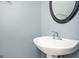 Small bathroom with pedestal sink and oval mirror at 308 Royal Crescent Way, Stockbridge, GA 30281