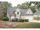 Two-story house with stone accents and a two-car garage at 308 Royal Crescent Way, Stockbridge, GA 30281