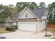 Two-story house with stone accents, a two-car garage, and basketball goal at 308 Royal Crescent Way, Stockbridge, GA 30281