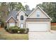 Two-story house with stone accents and a two-car garage at 308 Royal Crescent Way, Stockbridge, GA 30281