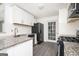 Modern kitchen with granite countertops and white cabinets at 308 Royal Crescent Way, Stockbridge, GA 30281