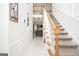 Elegant staircase with a built-in shelf and marble flooring at 308 Royal Crescent Way, Stockbridge, GA 30281