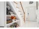 Open staircase with built-in shelving and white walls at 308 Royal Crescent Way, Stockbridge, GA 30281