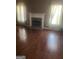 Living room with hardwood floors and a fireplace at 1546 Mine Run, Hampton, GA 30228