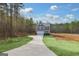 Two-story gray house with white garage door and landscaping at 60 Ascott Trce, Covington, GA 30016